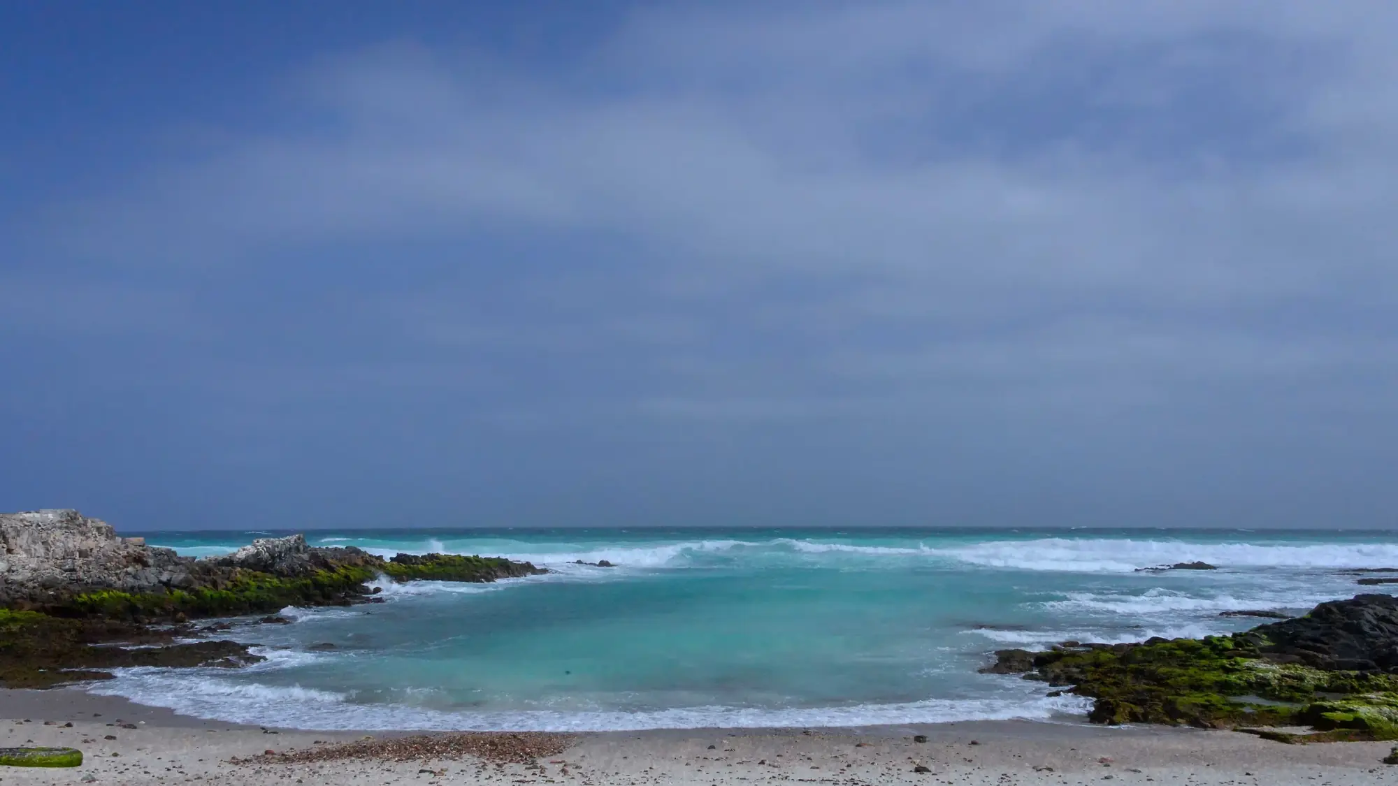 Turquoise water breaking over a reef on Socotra's coast