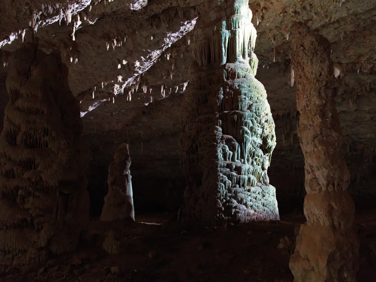 Stalagmites in the dark chambers of Hoq Cave